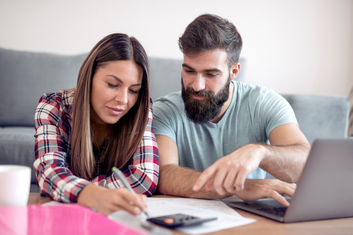Young couple reviewing their employer-sponsored retirement plan together.