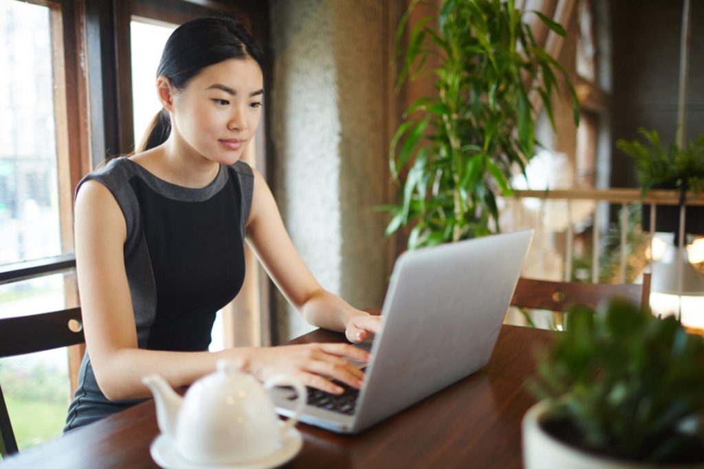 woman on a laptop learning about financial wellness